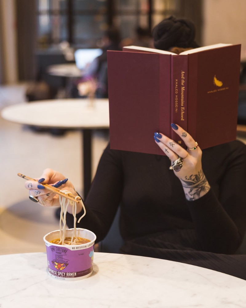 Woman reading while eating